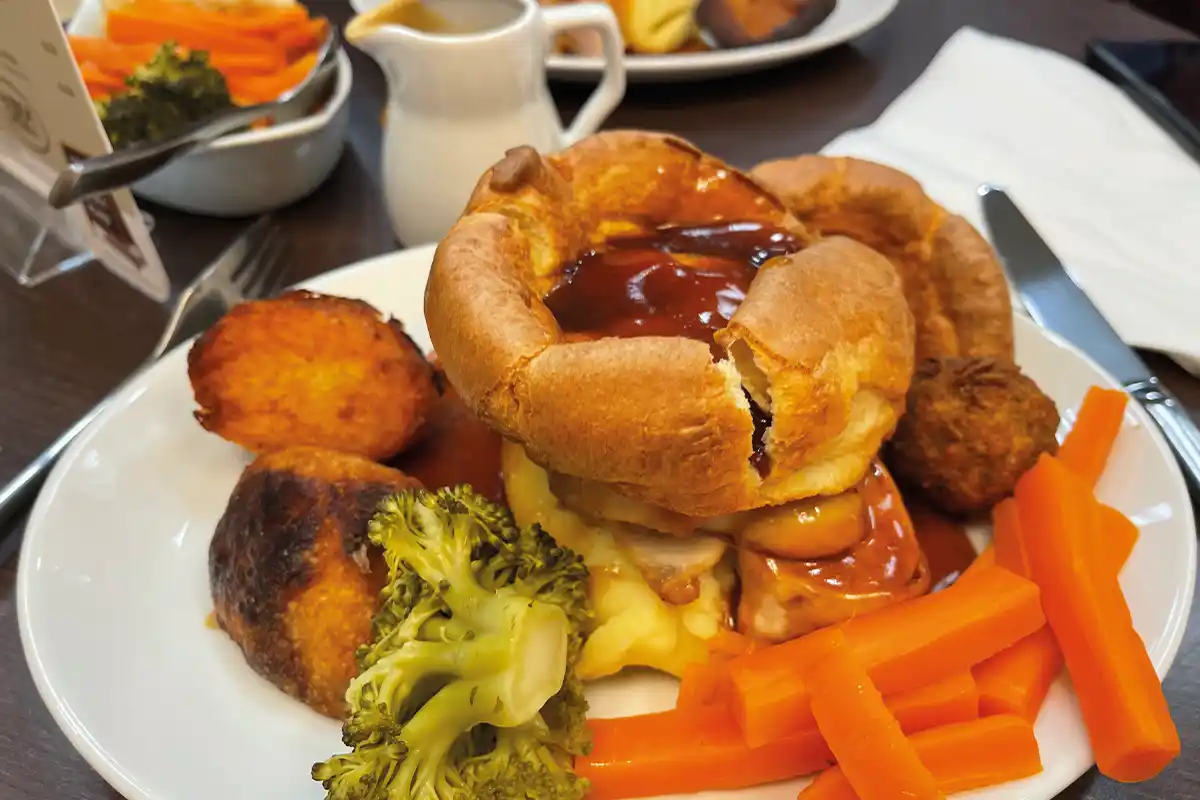 A roast dinner with yorkshire pudding, roast meat and vegetables. Prepared and served at the Basecamp Cafe in Towsure